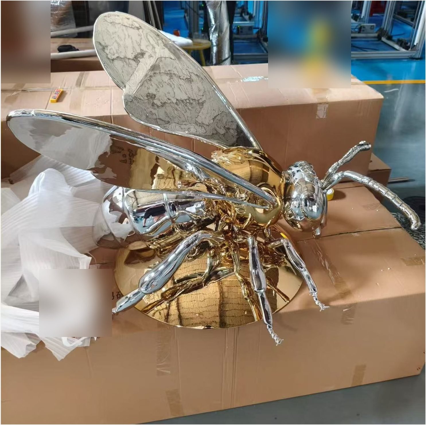 Side view of chrome wings and gold insect body