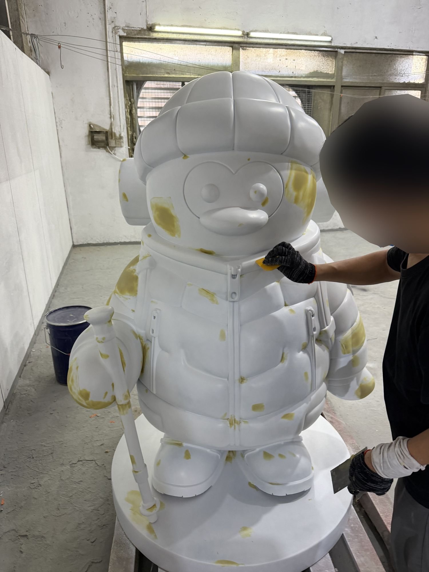 Custom mascot sculpture during surface preparation in the workshop