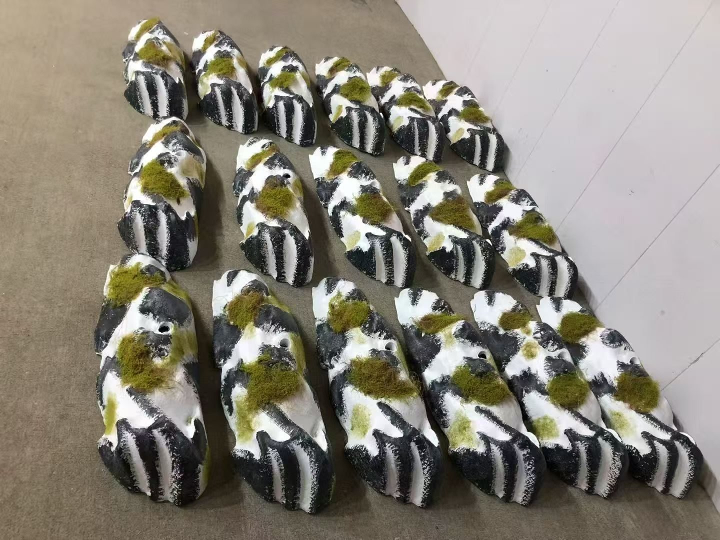 Rows of faux rock props with contrasting painted surfaces