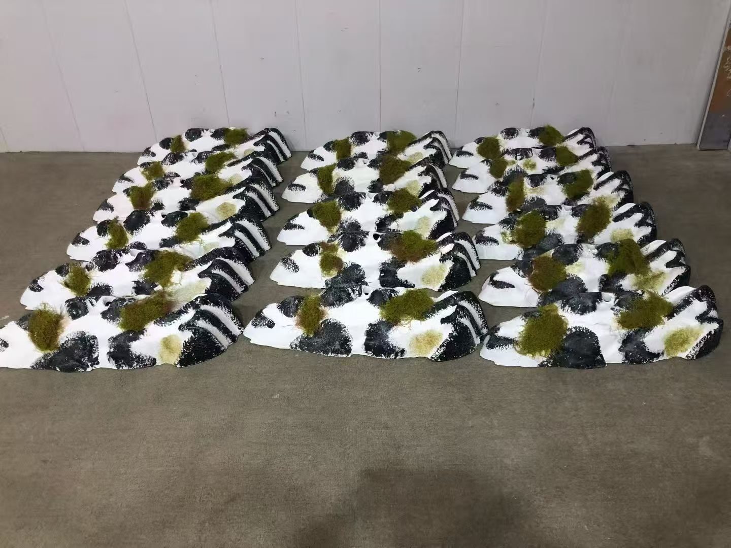 Coordinated rock and moss display modules on a workshop floor