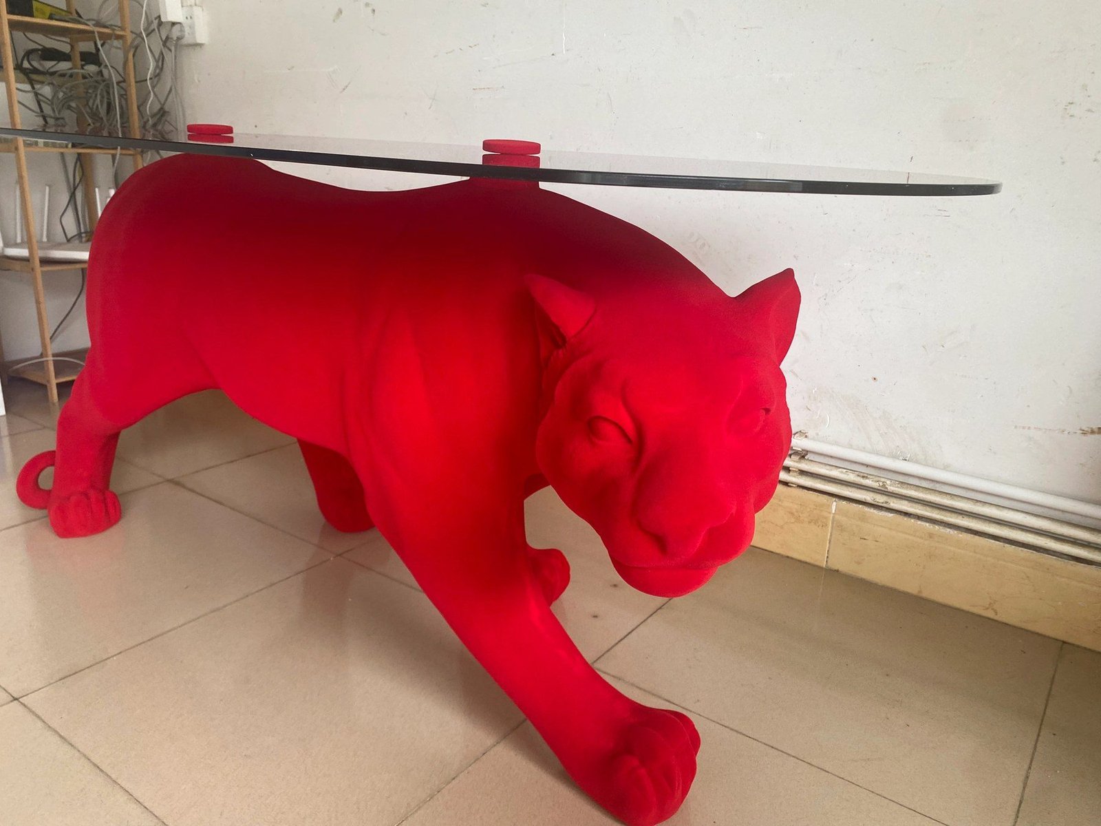 Angled view of the red flocked panther table