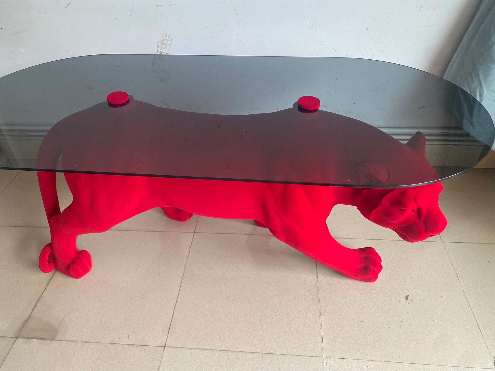 Elevated side view of the red flocked panther table