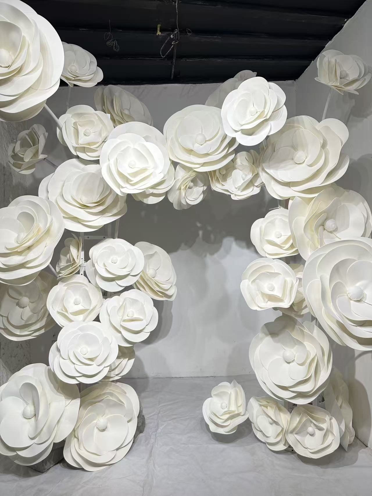 White flower display framing a large opening