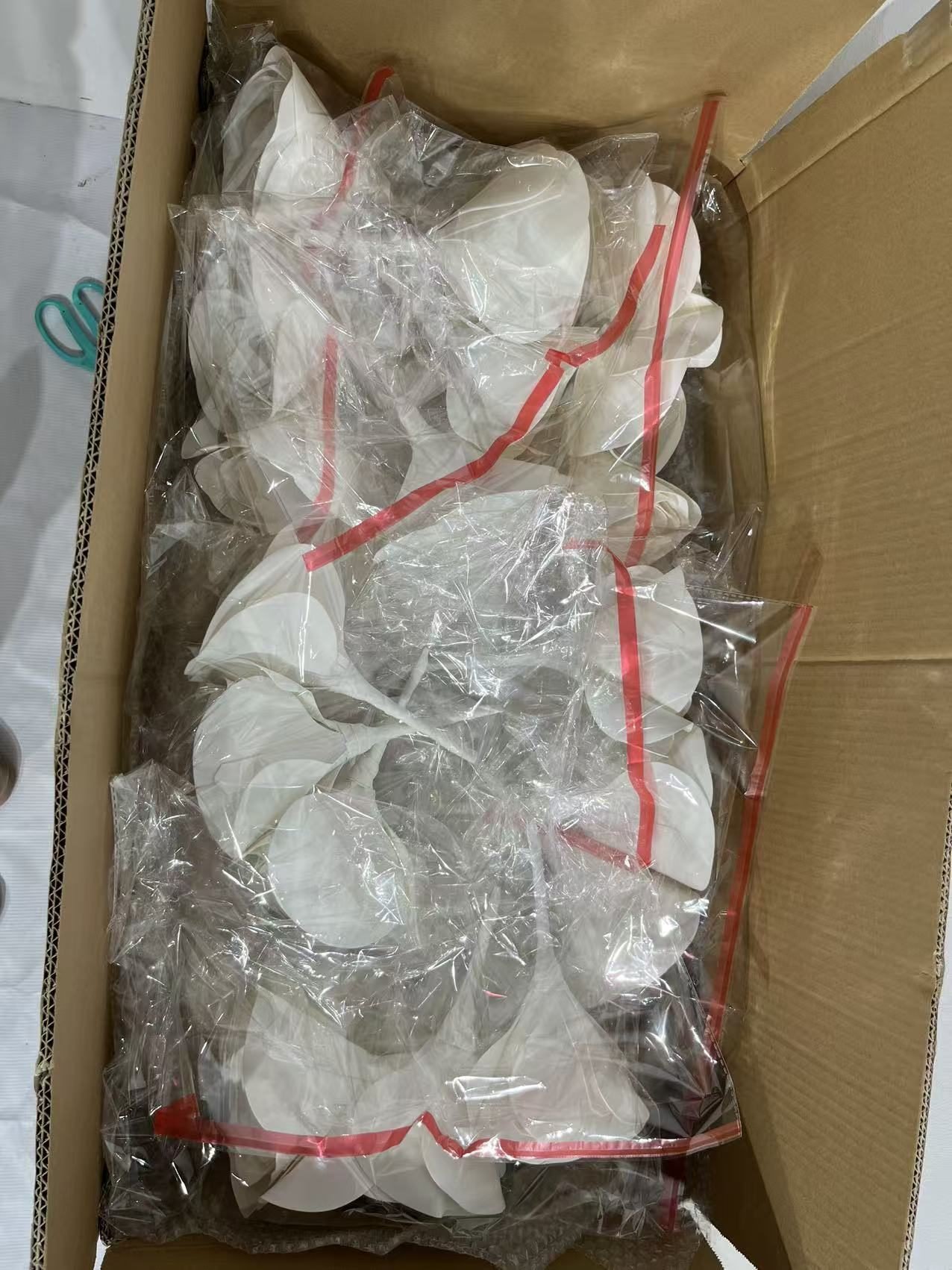 White flower components individually wrapped for packing
