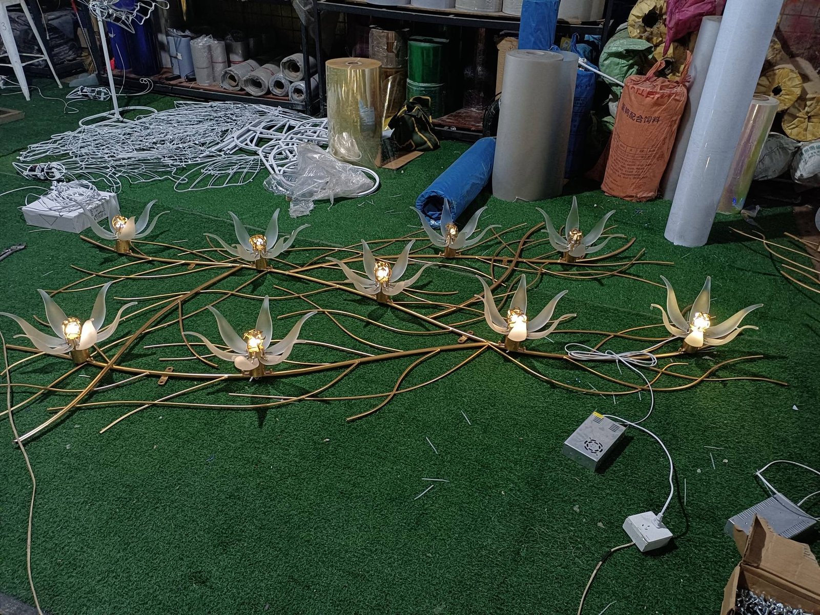 Acrylic flower display components arranged for a lighting check