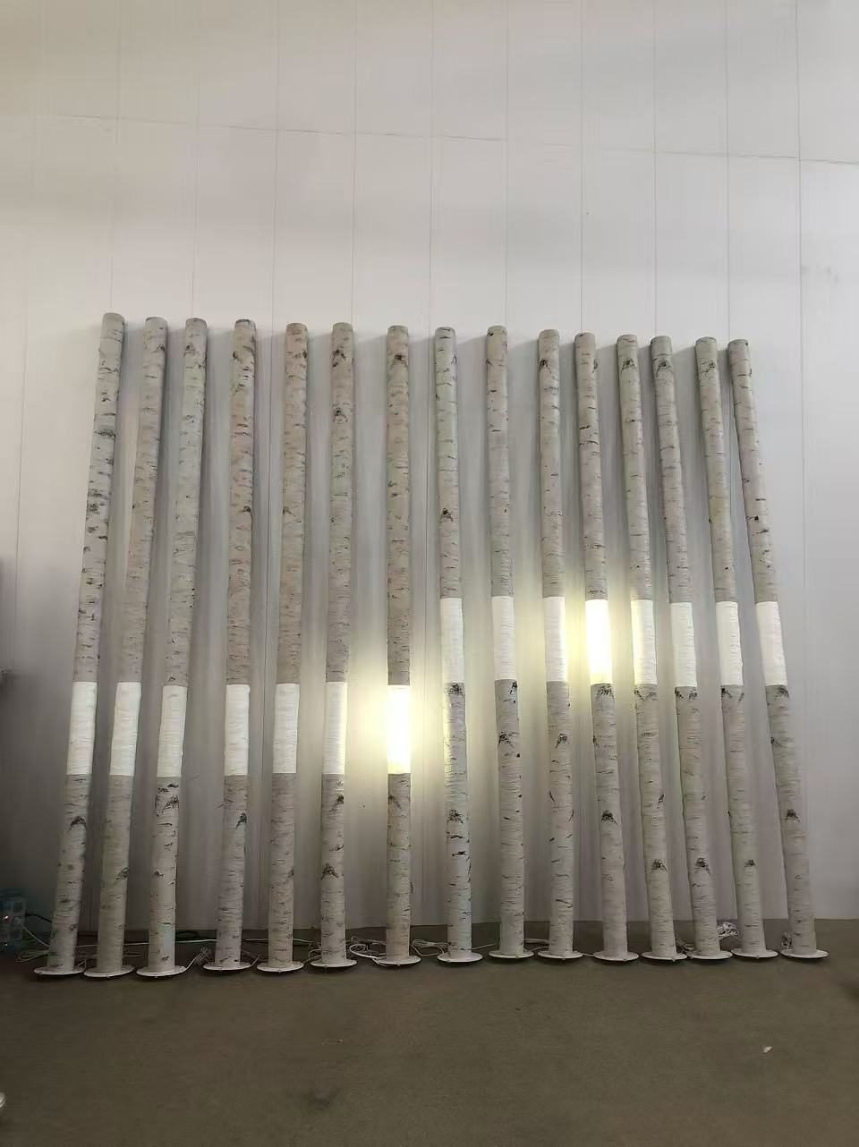 Batch of tall birch-style props with illuminated sections