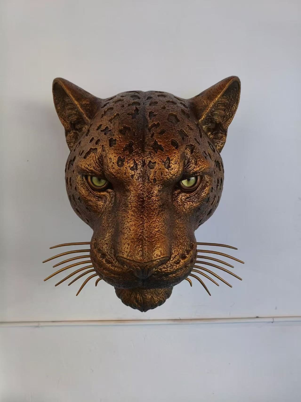 Leopard head wall sculpture with spotted bronze-tone finish