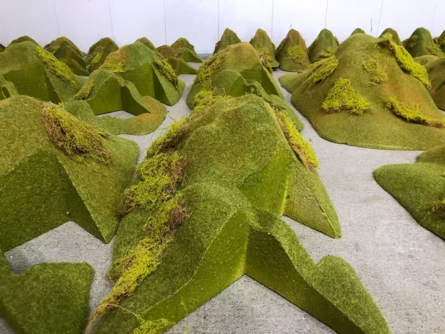 Angular terrain forms with textured green moss finishes