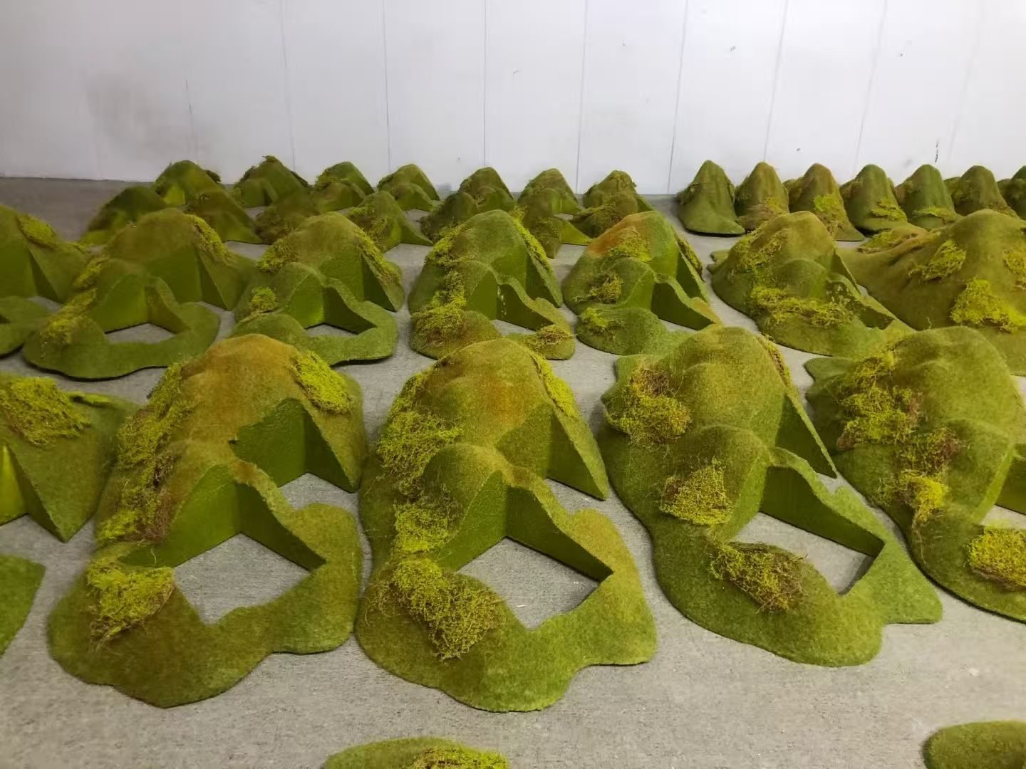 Coordinated green terrain display props in a workshop