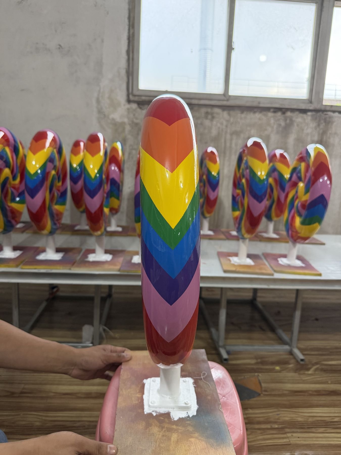 Edge profile and support of a rainbow spiral lollipop display prop.