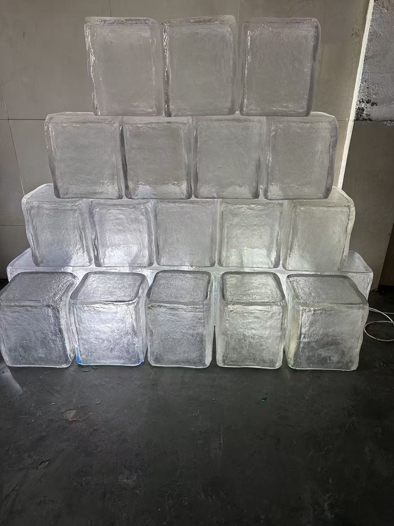 Transparent resin ice cube props stacked in a workshop