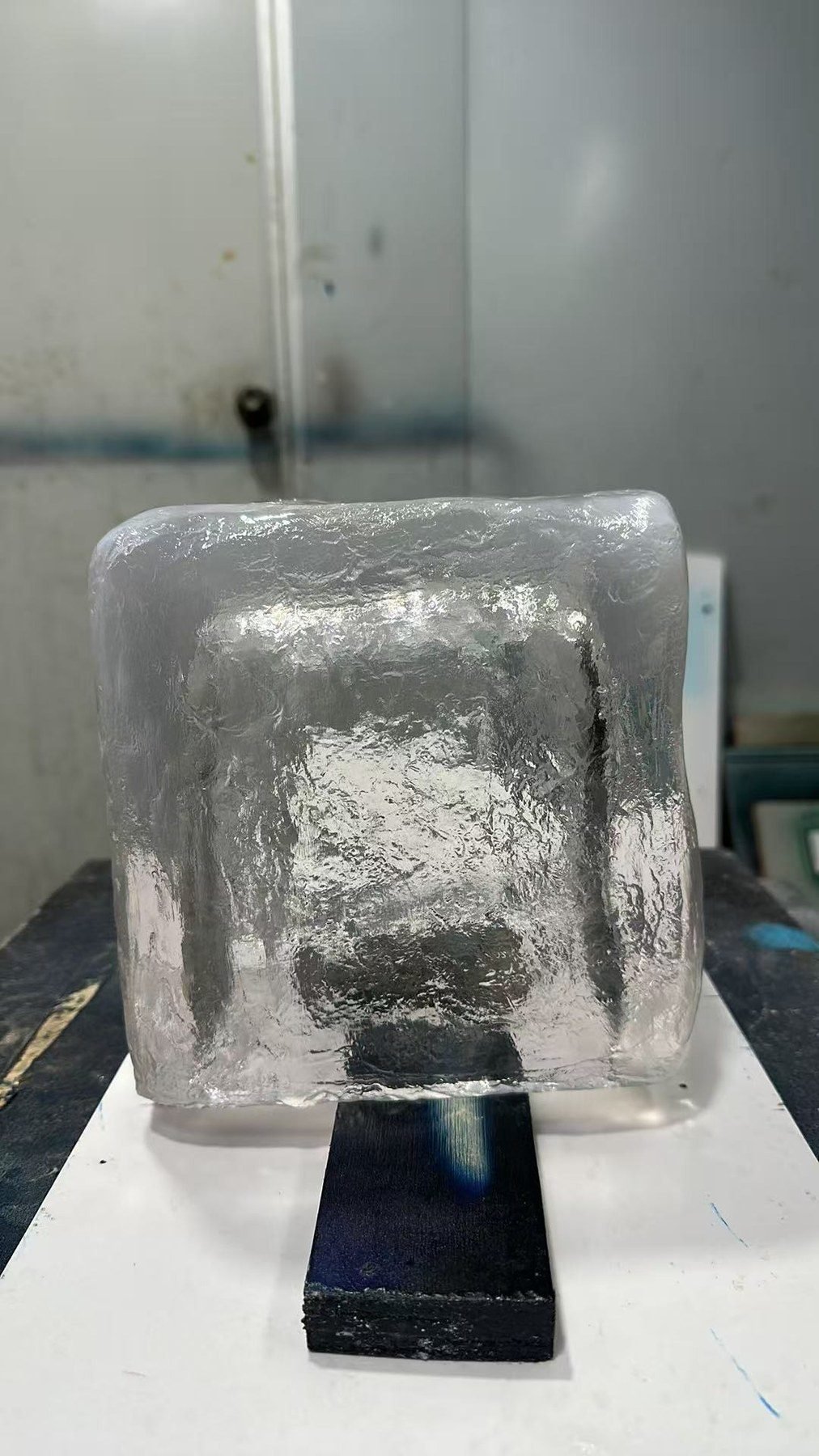 Clear resin ice cube prop with textured surfaces