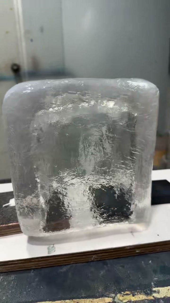 Front view of a transparent resin ice cube display prop