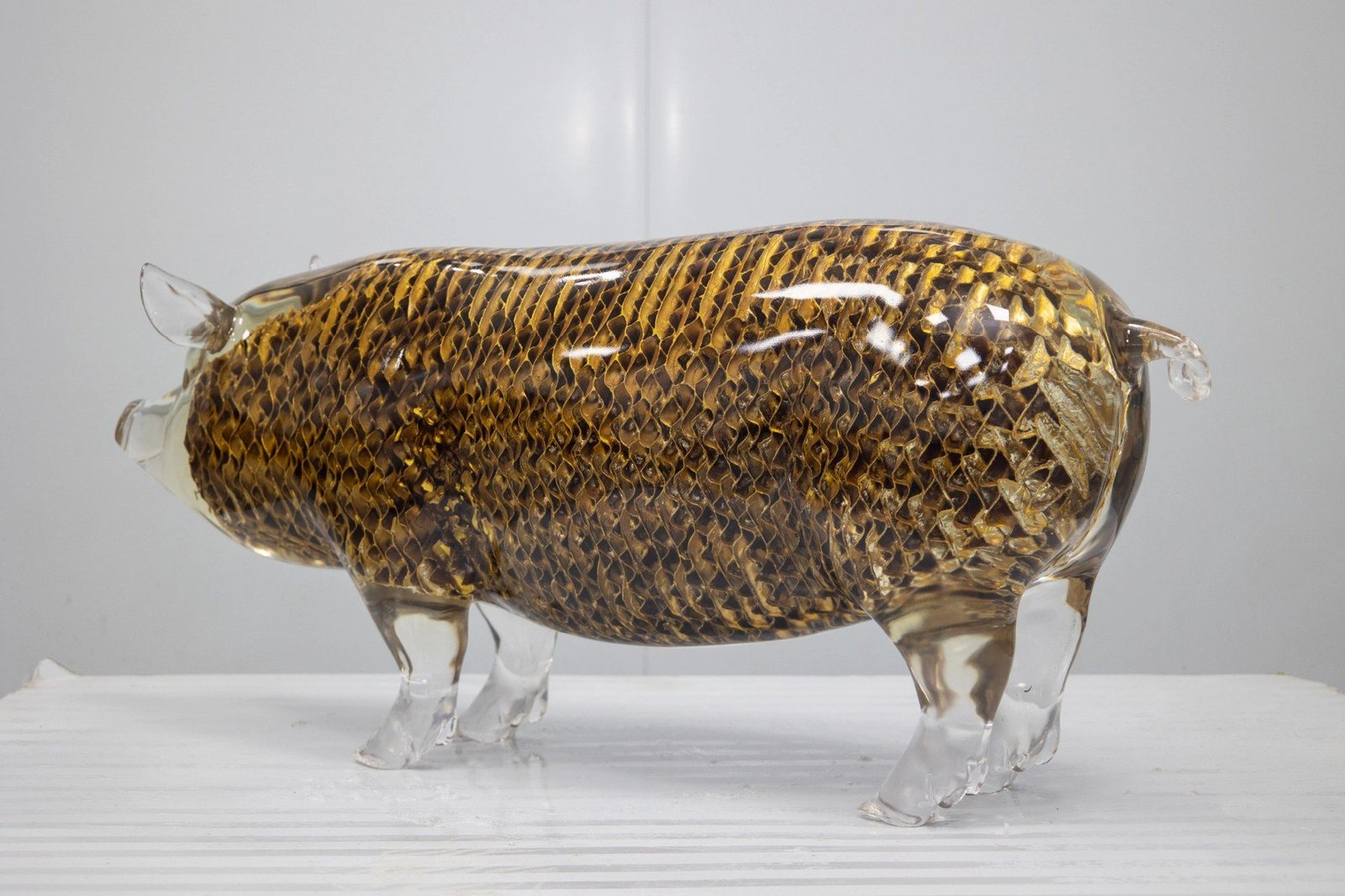 Rear side view of the transparent pig display sculpture