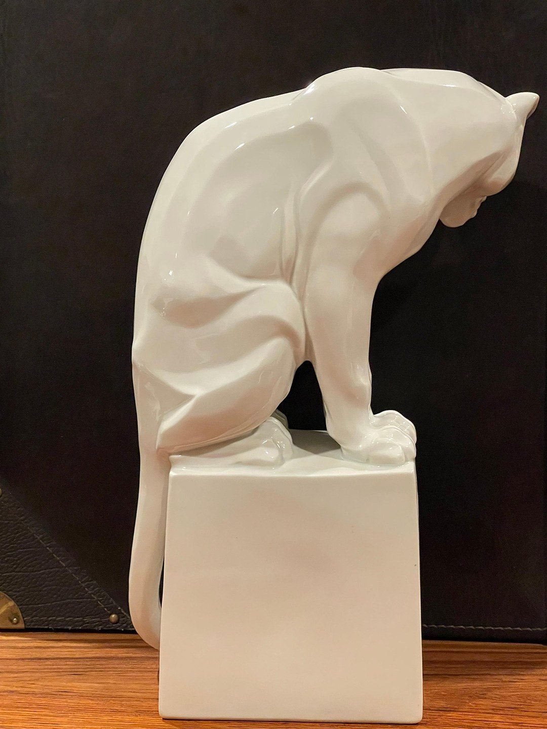 Rear view of a seated white panther sculpture